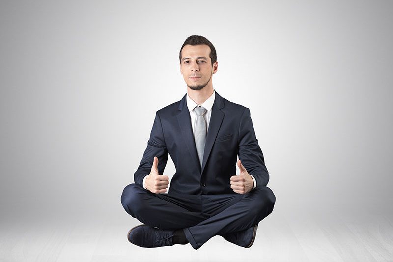 Businessman meditates in an empty space concept הפגת מתחים